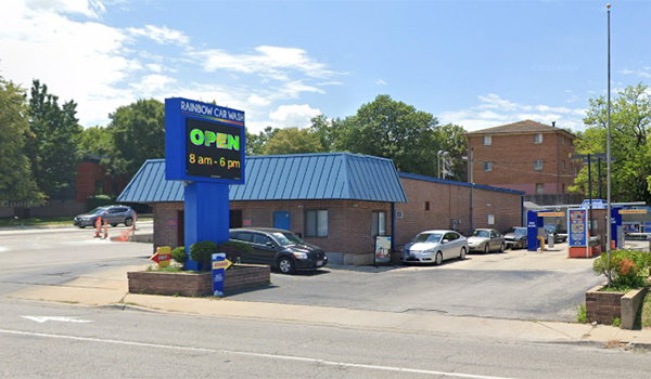 photo of building with blue roof and large sign.